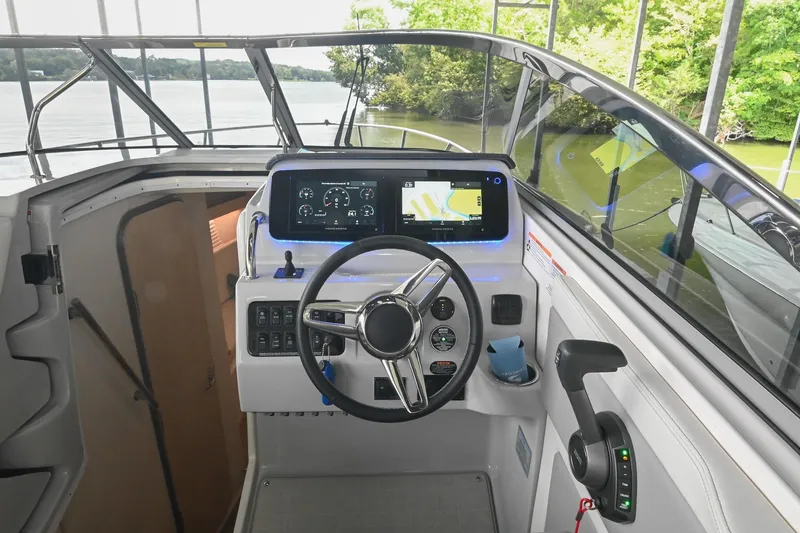 Slide: The Image of 2025 Regal 28 Express boat cockpit with modern steering and digital dashboard. - 25