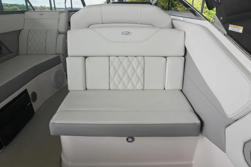 Slide: The Image of 2025 Regal 28 Express boat interior with luxurious white seating and diamond stitching. - 18
