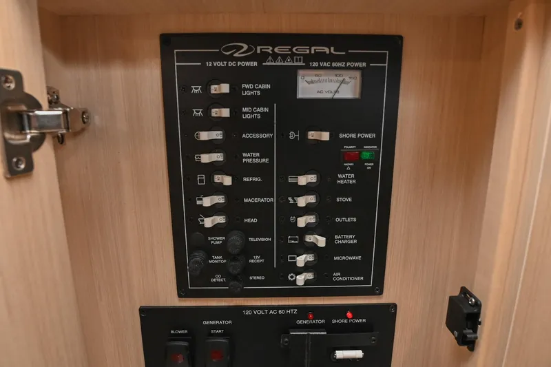 Slide: The Image of Control panel of 2025 Regal 28 Express boat, featuring switches for various onboard systems. - 47
