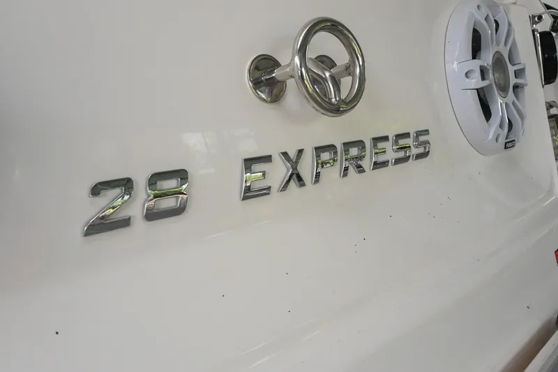 Slide: The Image of 2025 Regal 28 Express boat emblem and speaker detail. - 6