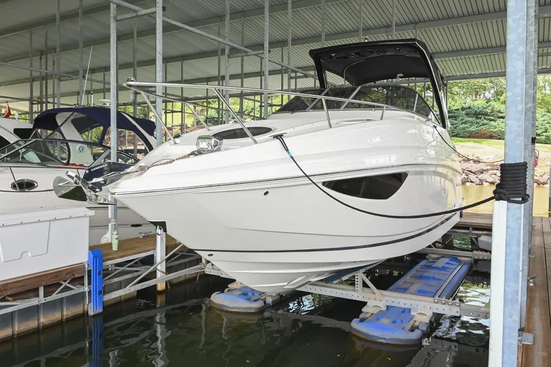 Slide: The Image of 2025 Regal 28 Express boat docked in a covered marina. - 4