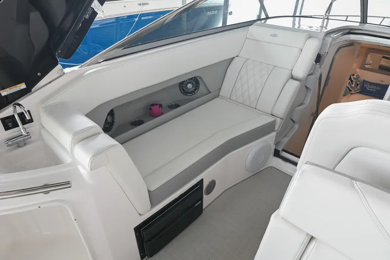 Slide: The Image of 2025 Regal 28 Express boat interior with white seating and modern amenities. - 21
