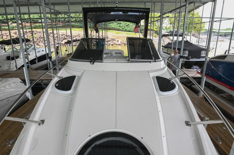 Slide: The Image of 2025 Regal 28 Express boat docked in a marina, showcasing sleek design and spacious deck. - 35