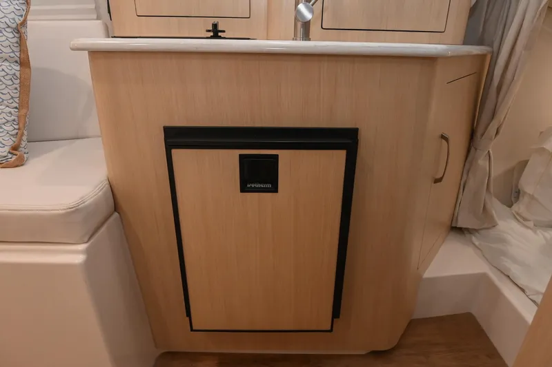 Slide: The Image of 2025 Regal 28 Express boat interior with compact kitchenette and modern design. - 39