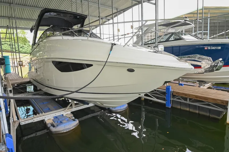 Slide: The Image of 2025 Regal 28 Express boat docked in a covered marina. - 3