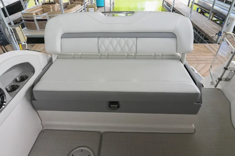 Slide: The Image of 2025 Regal 28 Express boat interior with cushioned seating and cup holders. - 16