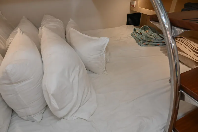 Slide: The Image of Cozy cabin bed with pillows in 2025 Regal 28 Express boat interior. - 50