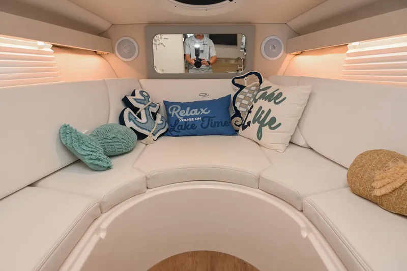 Slide: The Image of Luxurious interior of 2025 Regal 28 Express boat with cozy seating and decorative pillows. - 45