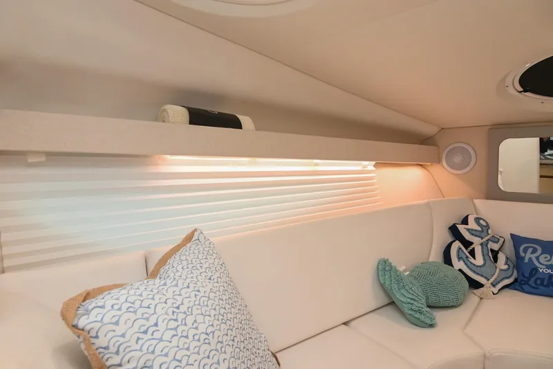 Slide: The Image of Interior of 2025 Regal 28 Express boat with cozy seating and decorative pillows. - 44