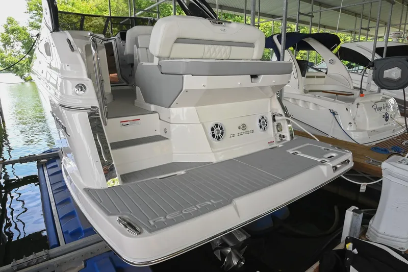 Slide: The Image of 2025 Regal 28 Express boat docked, showcasing sleek design and spacious seating area. - 7