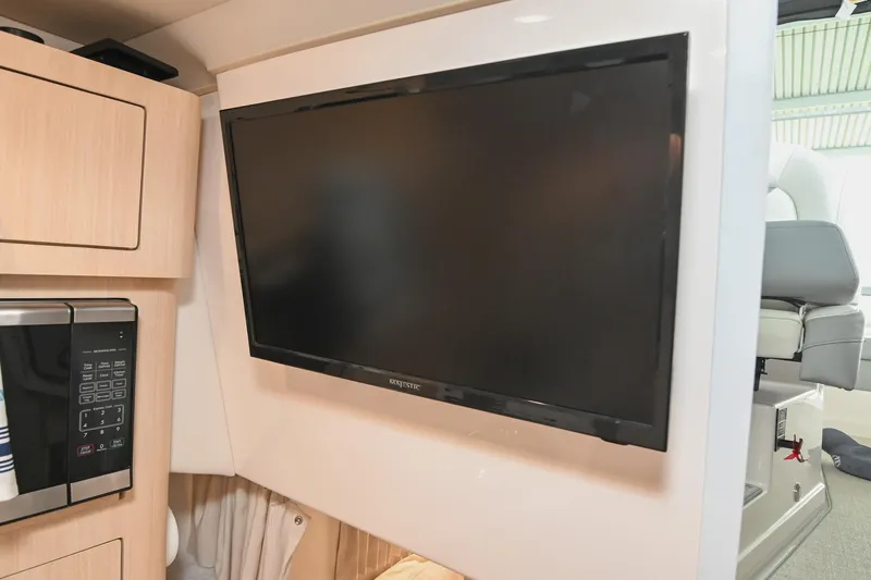 Slide: The Image of 2025 Regal 28 Express interior with mounted TV and microwave in cabin. - 40