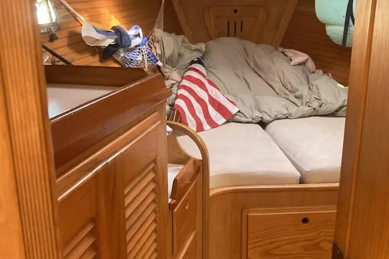 Slide: The Image of Cozy cabin interior of 1995 Freedom 45 CC sailboat with wooden finish and American flag. - 6