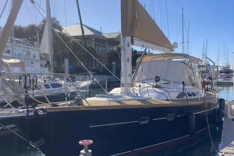 Slide: The Image of Sailboat Freedom 45 CC, 1995 model, docked in a marina under clear skies. - 3