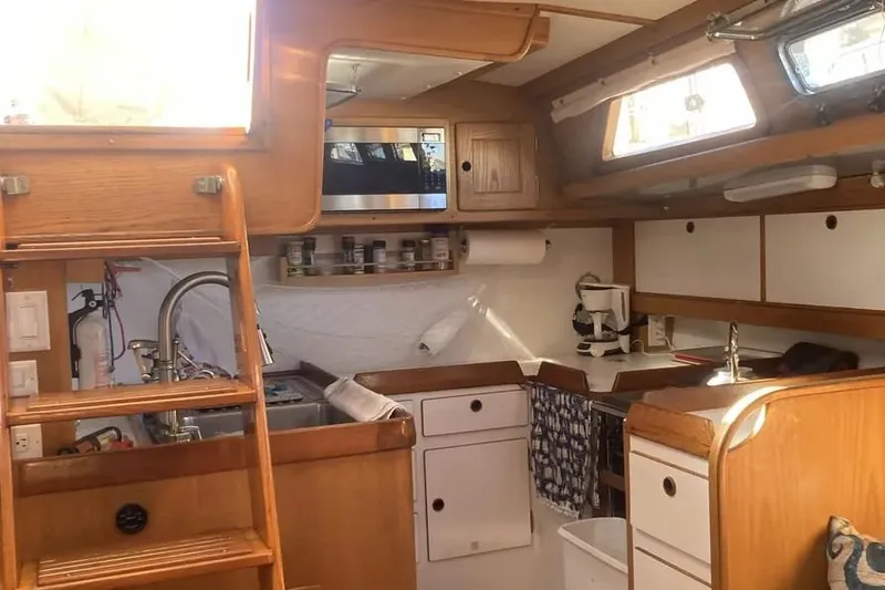 Slide: The Image of Cozy 1995 Freedom 45 CC yacht kitchen with wooden cabinetry and modern appliances. - 9