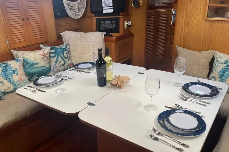 Slide: The Image of Dining area in a 1995 Freedom 45 CC yacht with elegant table setting. - 15