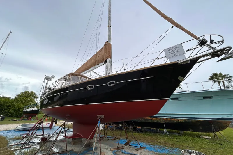 Slide: The Image of Sailboat Freedom 45 CC 1995 on stands, for sale, with overcast sky background. - 24