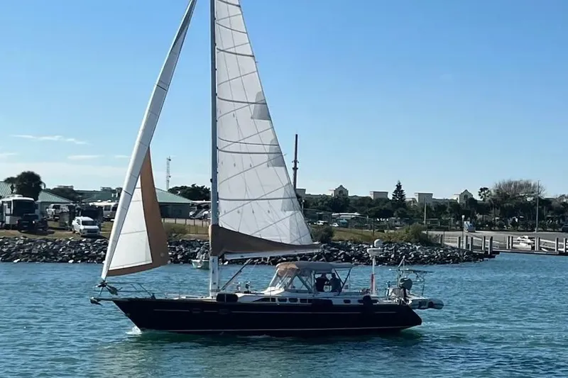 The Image of Sailing yacht Freedom 45 CC, 1995 model, cruising on a sunny day near the shore. - 2