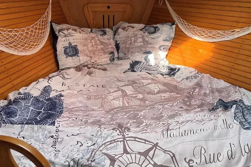 Slide: The Image of Cozy cabin bed in 1995 Freedom 45 CC sailboat with nautical-themed bedding. - 7