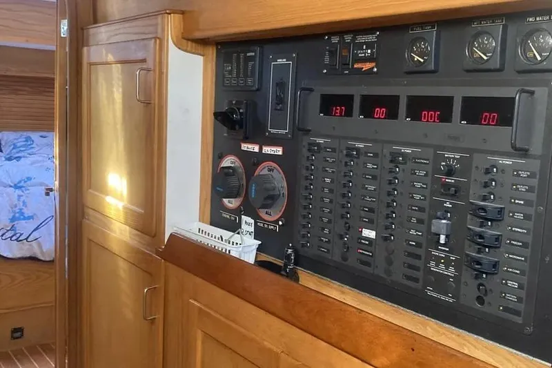 Slide: The Image of Electrical control panel inside a 1995 Freedom 45 CC yacht, featuring gauges and switches. - 11
