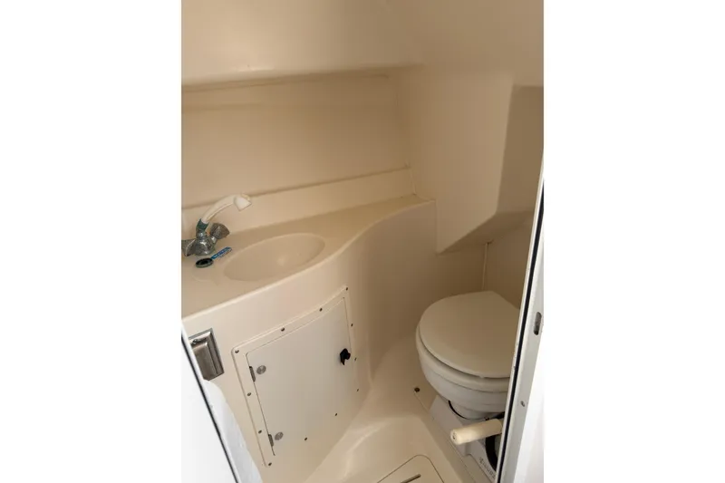 Slide: The Image of 1998 Pursuit 2860 Denali boat bathroom with sink and toilet. - 4