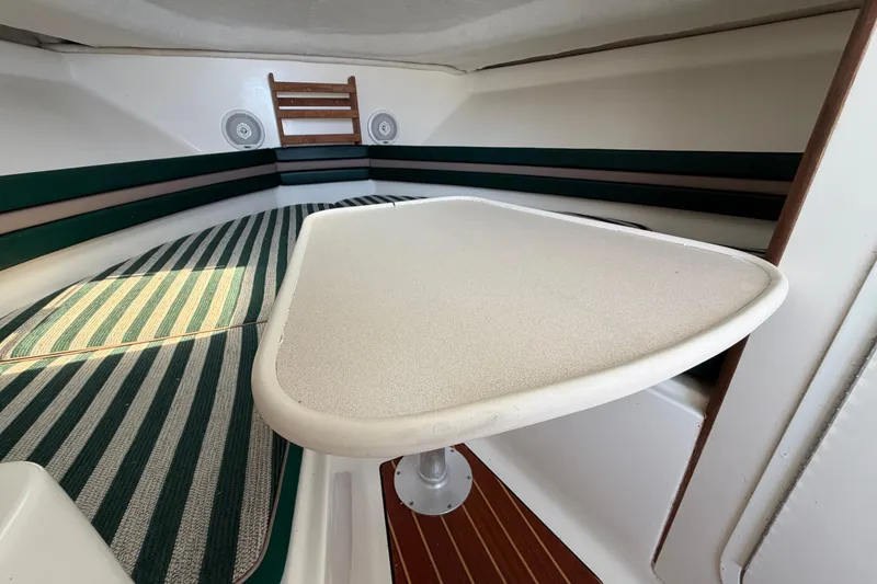 Slide: The Image of Interior of 1998 Pursuit 2860 Denali boat with striped seating and table. - 3