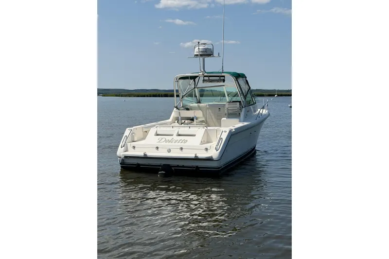 Slide: The Image of 1998 Pursuit 2860 Denali boat named Dolcetto on calm water under blue sky. - 16