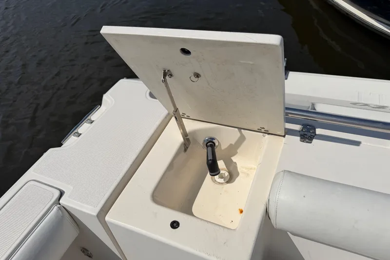 Slide: The Image of Open hatch with faucet on 1998 Pursuit 2860 Denali boat, docked by water. - 8