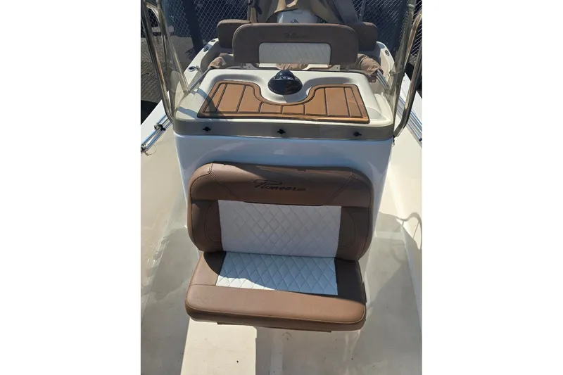 Slide: The Image of 2023 Pioneer 180 Islander boat interior with cushioned seating and console. - 3