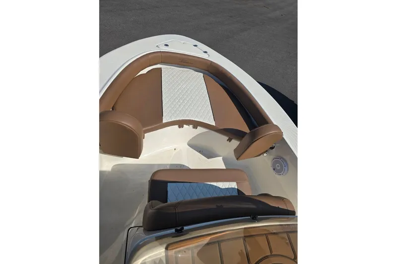 Slide: The Image of 2023 Pioneer 180 Islander boat interior with brown and white seating. - 2