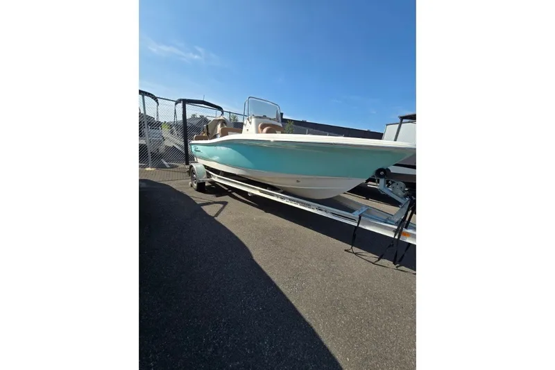 The Image of 2023 Pioneer 180 Islander boat on trailer, displayed outdoors under clear blue sky. - 0