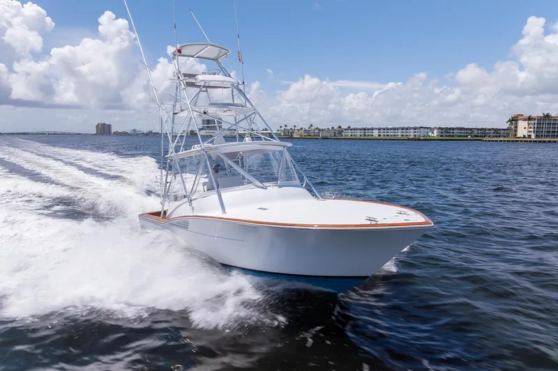 Slide: The Image of 2001 Predator Express boat cruising on open water under a clear blue sky. - 1