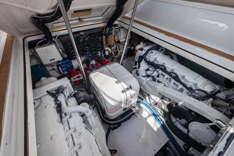 Slide: The Image of Engine compartment of a 2001 Predator Express boat, showcasing dual engines and wiring. - 49