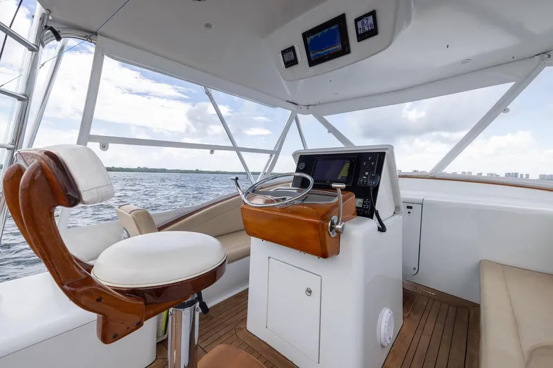 Slide: The Image of Interior of 2001 Predator Express boat with helm, steering wheel, and navigation equipment. - 16