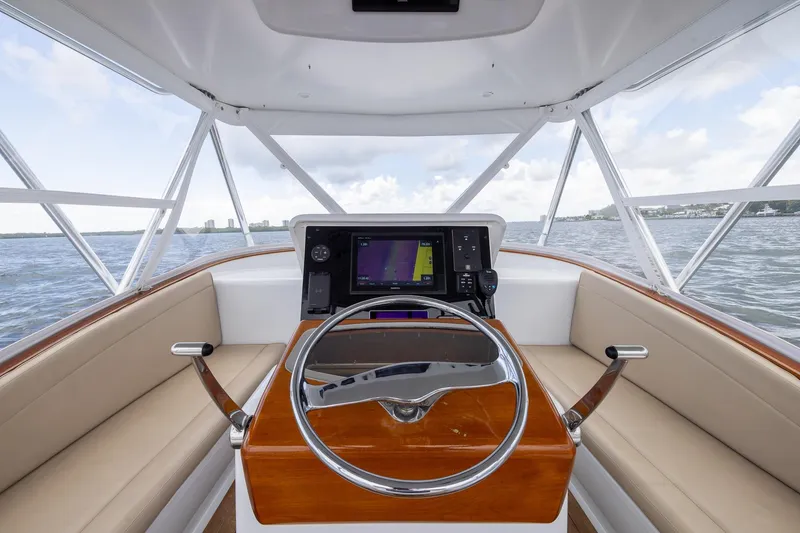 Slide: The Image of Helm of 2001 Predator Express boat with navigation system, steering wheel, and panoramic water view. - 17