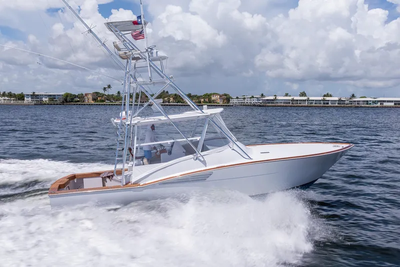 Slide: The Image of 2001 Predator Express boat cruising on water under a cloudy sky. - 7