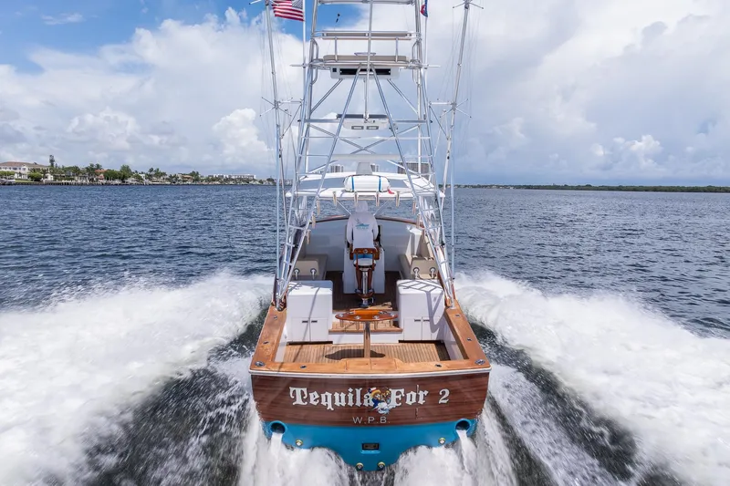 Slide: The Image of 2001 Predator Express boat "Tequila For 2" cruising on open water, rear view. - 9
