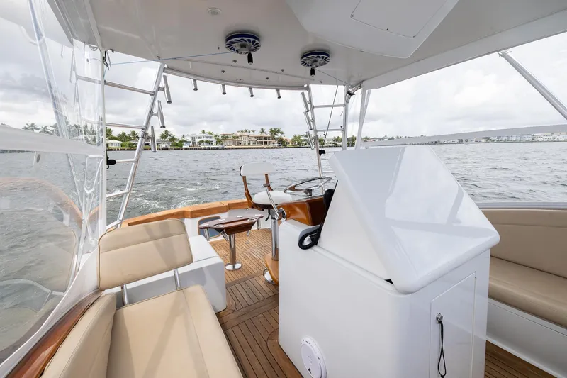 Slide: The Image of Interior view of 2001 Predator Express boat with seating and helm, overlooking water. - 15