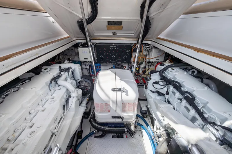 Slide: The Image of Engine room of a 2001 Predator Express boat, showcasing dual engines and control panel. - 48