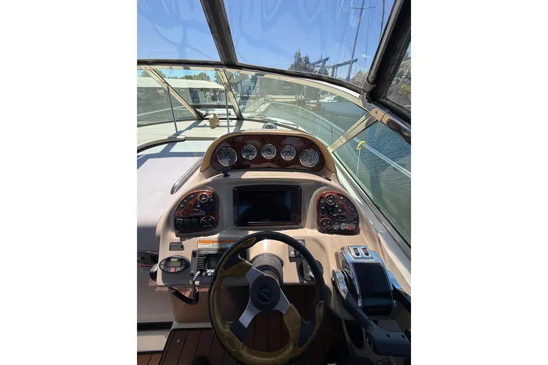 Slide: The Image of Cockpit view of 2005 Sea Ray 300 Sundancer boat with steering wheel and control panel. - 9