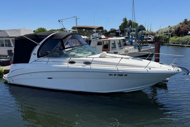 Slide: The Image of 2005 Sea Ray 300 Sundancer boat docked in a marina under clear blue skies. - 15