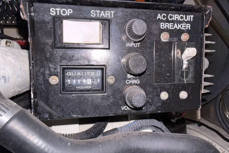 Slide: The Image of Control panel of a 2005 Sea Ray 300 Sundancer boat with AC circuit breaker. - 16