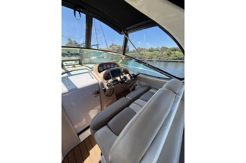 Slide: The Image of Cockpit view of 2005 Sea Ray 300 Sundancer boat with steering wheel and dashboard. - 7