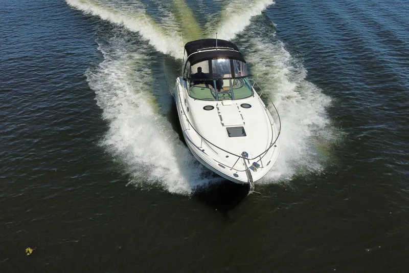 Slide: The Image of 2005 Sea Ray 300 Sundancer cruising on open water, creating a dynamic wake. - 4