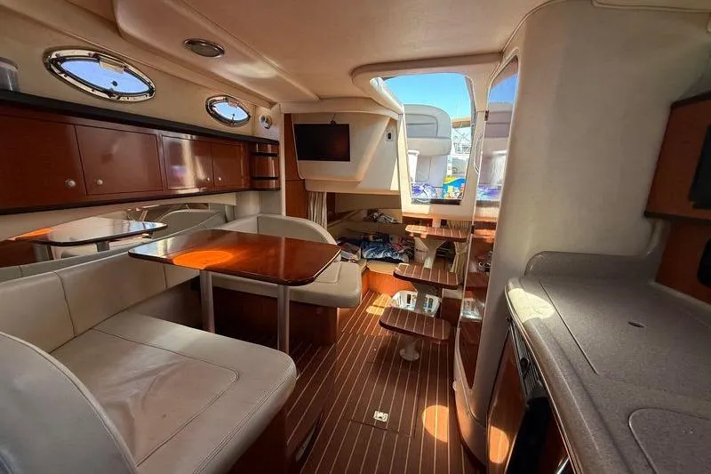 Slide: The Image of Interior of 2005 Sea Ray 300 Sundancer yacht with elegant wood finish and seating area. - 14