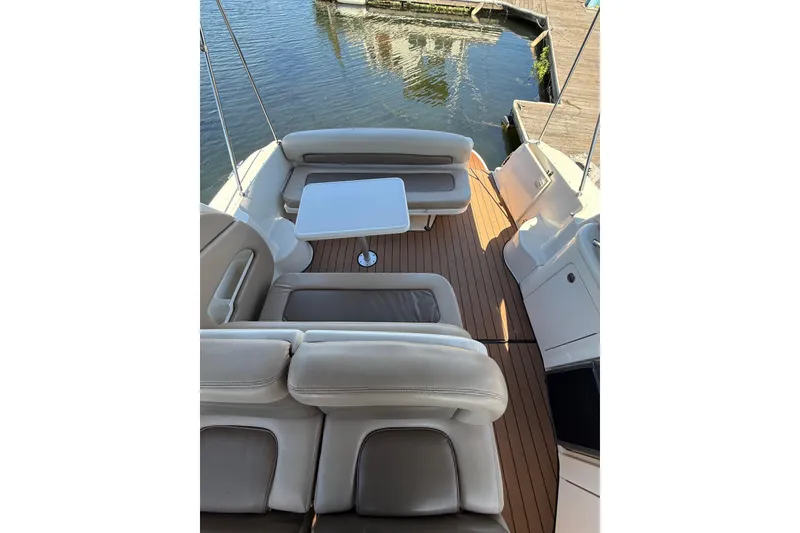 Slide: The Image of Luxurious 2005 Sea Ray 300 Sundancer boat interior with plush seating and table. - 8