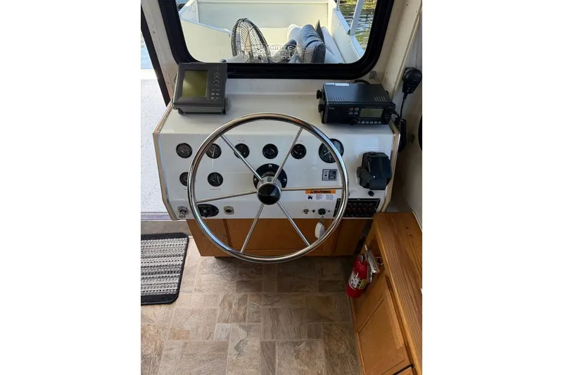 Slide: The Image of Steering console of a 1998 Patio Cruiser 55 boat with navigation equipment. - 18