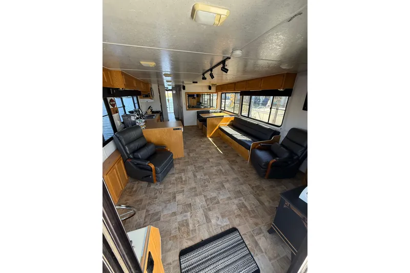 Slide: The Image of Interior of a 1998 Patio Cruiser 55 houseboat with seating and wood cabinetry. - 13