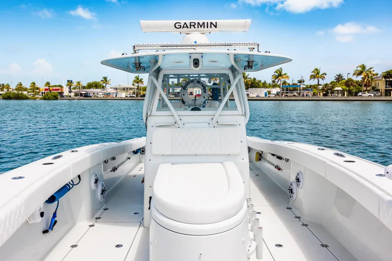 Slide: The Image of 2024 Freeman 34VH boat on water, featuring Garmin equipment, with coastal scenery in the background. - 22