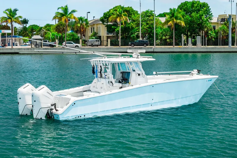 The Image of 2024 Freeman 34VH boat with dual engines on a sunny waterfront. - 0