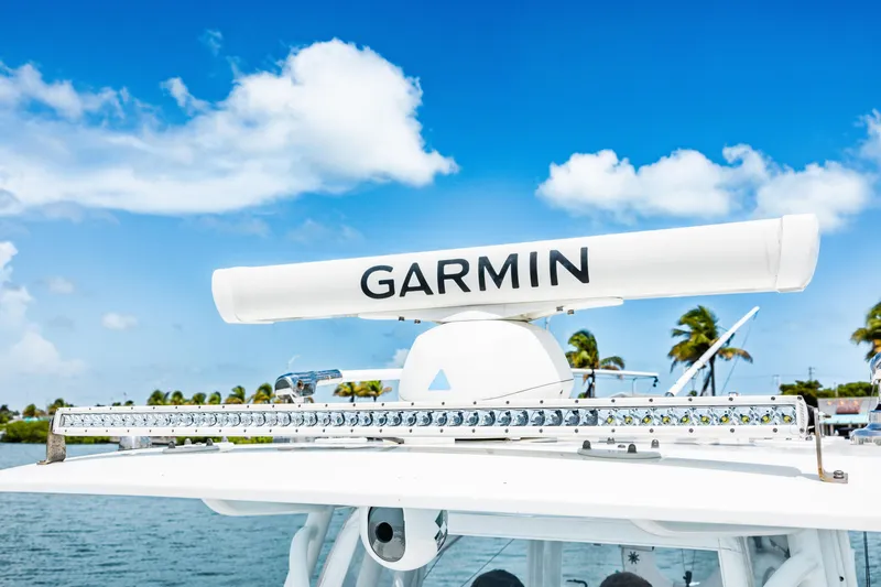 Slide: The Image of 2024 Freeman 34VH boat with Garmin radar, clear blue sky background. - 38